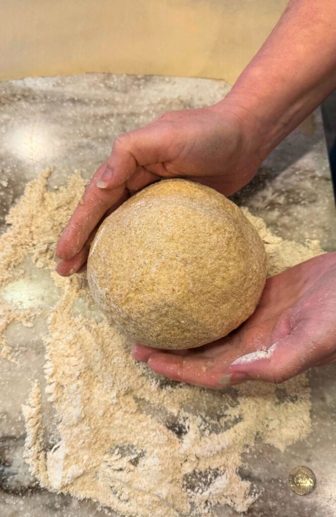 hands shaping the loaf